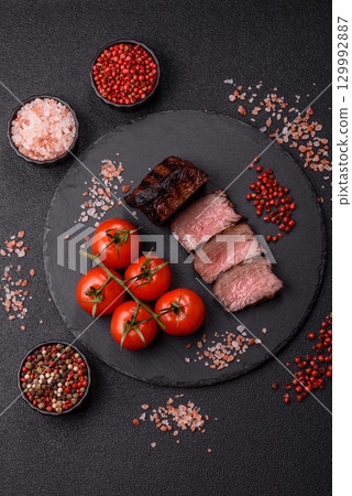 Grilled beef steak meat with salt and pepper. Beef steak grilled on a barbecue Grilled beef steak meat with salt and pepper. Beef steak grilled on a barbecue 129992887