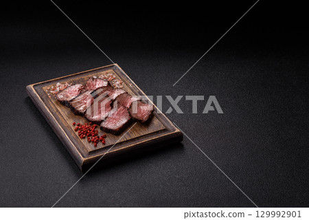 Grilled beef steak meat with salt and pepper. Beef steak grilled on a barbecue Grilled beef steak meat with salt and pepper. Beef steak grilled on a barbecue 129992901