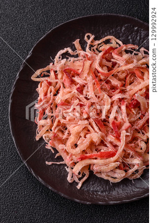 Food, dried squid in shavings or chopped as snacks or jerky. Snack dried squid for beer Food, dried squid in shavings or chopped as snacks or jerky. Snack dried squid for beer 129992924