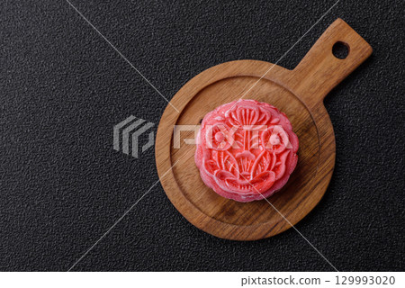 Chinese mooncake is an Asian sweet dessert. Asian mooncake as a background for your design 129993020