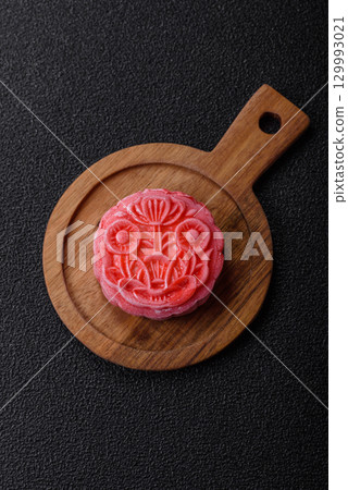 Chinese mooncake is an Asian sweet dessert. Asian mooncake as a background for your design 129993021
