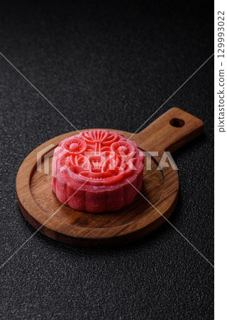 Chinese mooncake is an Asian sweet dessert. Asian mooncake as a background for your design Chinese mooncake is an Asian sweet dessert. Asian mooncake as a background for your design 129993022