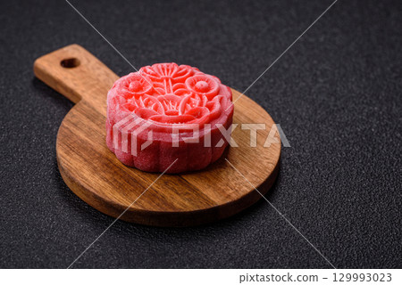 Chinese mooncake is an Asian sweet dessert. Asian mooncake as a background for your design Chinese mooncake is an Asian sweet dessert. Asian mooncake as a background for your design 129993023
