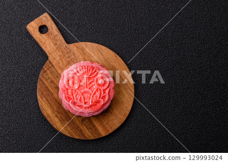 Chinese mooncake is an Asian sweet dessert. Asian mooncake as a background for your design 129993024