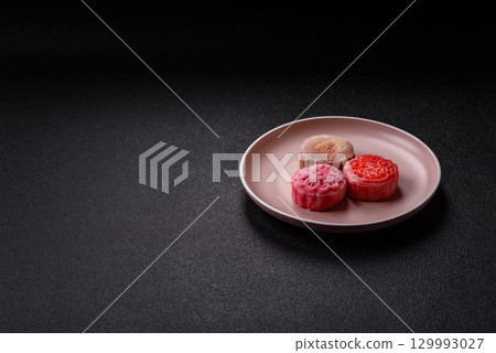 Chinese mooncake is an Asian sweet dessert. Asian mooncake as a background for your design Chinese mooncake is an Asian sweet dessert. Asian mooncake as a background for your design 129993027