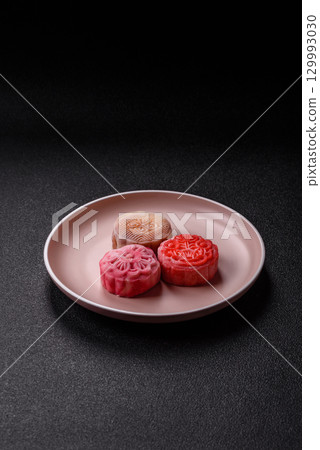 Chinese mooncake is an Asian sweet dessert. Asian mooncake as a background for your design Chinese mooncake is an Asian sweet dessert. Asian mooncake as a background for your design 129993030