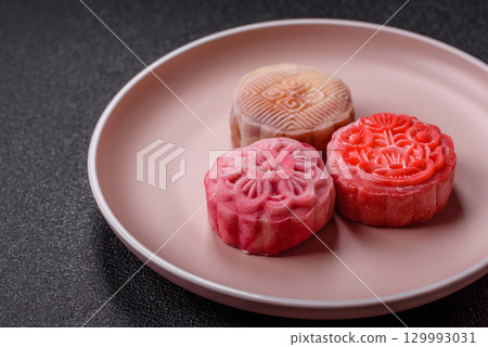 Chinese mooncake is an Asian sweet dessert. Asian mooncake as a background for your design 129993031