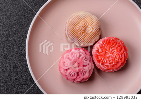 Chinese mooncake is an Asian sweet dessert. Asian mooncake as a background for your design 129993032