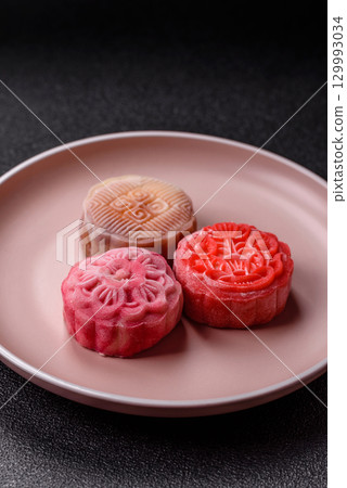 Chinese mooncake is an Asian sweet dessert. Asian mooncake as a background for your design 129993034