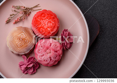 Chinese mooncake is an Asian sweet dessert. Asian mooncake as a background for your design Chinese mooncake is an Asian sweet dessert. Asian mooncake as a background for your design 129993036