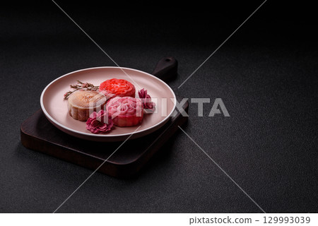 Chinese mooncake is an Asian sweet dessert. Asian mooncake as a background for your design Chinese mooncake is an Asian sweet dessert. Asian mooncake as a background for your design 129993039