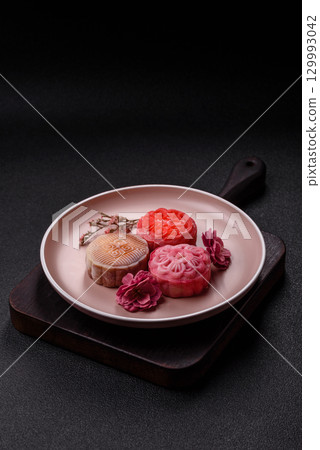 Chinese mooncake is an Asian sweet dessert. Asian mooncake as a background for your design 129993042