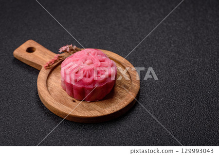 Chinese mooncake is an Asian sweet dessert. Asian mooncake as a background for your design 129993043