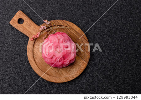 Chinese mooncake is an Asian sweet dessert. Asian mooncake as a background for your design Chinese mooncake is an Asian sweet dessert. Asian mooncake as a background for your design 129993044