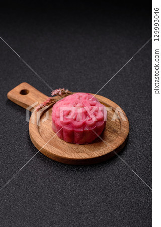 Chinese mooncake is an Asian sweet dessert. Asian mooncake as a background for your design Chinese mooncake is an Asian sweet dessert. Asian mooncake as a background for your design 129993046