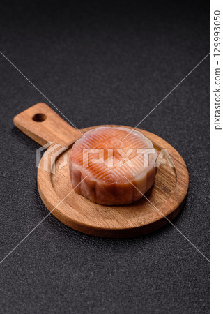 Chinese mooncake is an Asian sweet dessert. Asian mooncake as a background for your design Chinese mooncake is an Asian sweet dessert. Asian mooncake as a background for your design 129993050