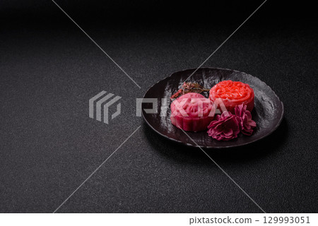 Chinese mooncake is an Asian sweet dessert. Asian mooncake as a background for your design 129993051