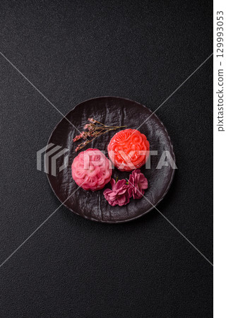 Chinese mooncake is an Asian sweet dessert. Asian mooncake as a background for your design 129993053