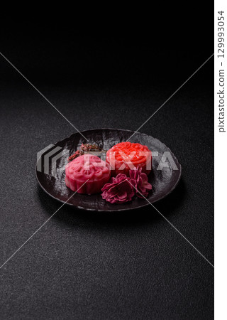 Chinese mooncake is an Asian sweet dessert. Asian mooncake as a background for your design 129993054