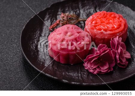 Chinese mooncake is an Asian sweet dessert. Asian mooncake as a background for your design 129993055
