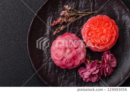 Chinese mooncake is an Asian sweet dessert. Asian mooncake as a background for your design 129993056