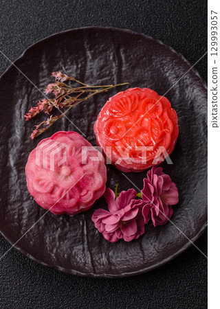 Chinese mooncake is an Asian sweet dessert. Asian mooncake as a background for your design 129993057