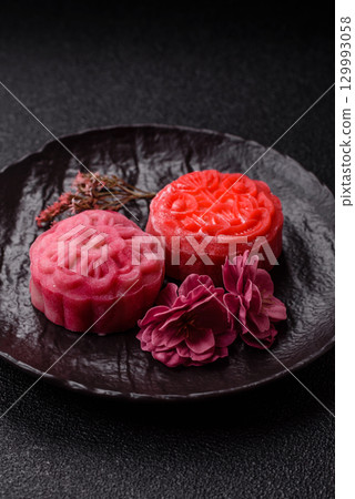 Chinese mooncake is an Asian sweet dessert. Asian mooncake as a background for your design 129993058