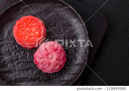 Chinese mooncake is an Asian sweet dessert. Asian mooncake as a background for your design Chinese mooncake is an Asian sweet dessert. Asian mooncake as a background for your design 129993060
