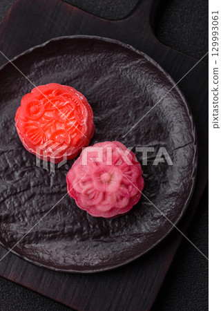 Chinese mooncake is an Asian sweet dessert. Asian mooncake as a background for your design 129993061