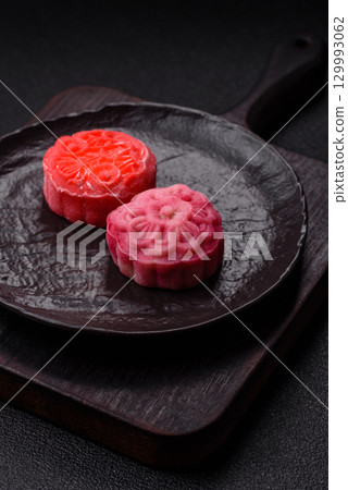 Chinese mooncake is an Asian sweet dessert. Asian mooncake as a background for your design Chinese mooncake is an Asian sweet dessert. Asian mooncake as a background for your design 129993062
