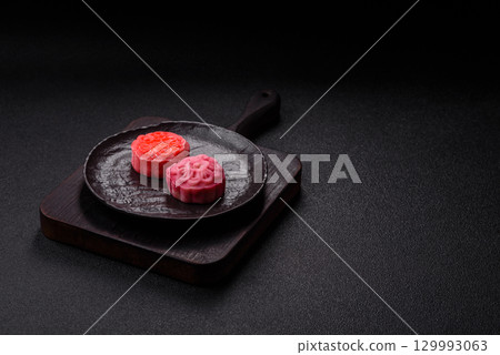 Chinese mooncake is an Asian sweet dessert. Asian mooncake as a background for your design 129993063