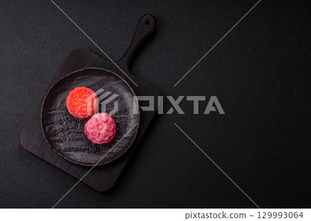 Chinese mooncake is an Asian sweet dessert. Asian mooncake as a background for your design 129993064