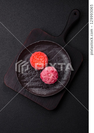 Chinese mooncake is an Asian sweet dessert. Asian mooncake as a background for your design 129993065