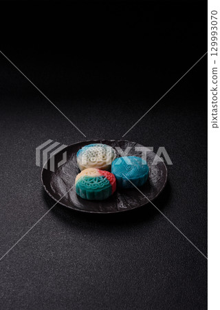 Chinese mooncake is an Asian sweet dessert. Asian mooncake as a background for your design 129993070