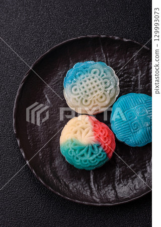 Chinese mooncake is an Asian sweet dessert. Asian mooncake as a background for your design 129993073