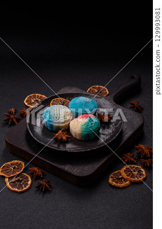 Chinese mooncake is an Asian sweet dessert. Asian mooncake as a background for your design 129993081