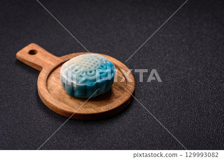 Chinese mooncake is an Asian sweet dessert. Asian mooncake as a background for your design 129993082