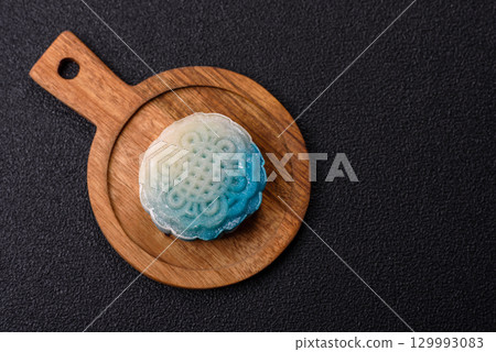 Chinese mooncake is an Asian sweet dessert. Asian mooncake as a background for your design 129993083