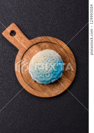 Chinese mooncake is an Asian sweet dessert. Asian mooncake as a background for your design 129993084