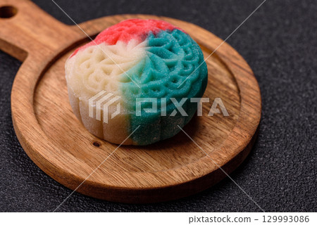 Chinese mooncake is an Asian sweet dessert. Asian mooncake as a background for your design 129993086