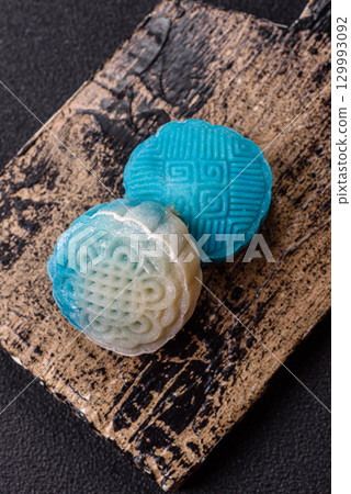 Chinese mooncake is an Asian sweet dessert. Asian mooncake as a background for your design Chinese mooncake is an Asian sweet dessert. Asian mooncake as a background for your design 129993092