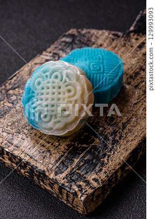 Chinese mooncake is an Asian sweet dessert. Asian mooncake as a background for your design 129993093