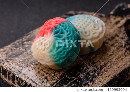 Chinese mooncake is an Asian sweet dessert. Asian mooncake as a background for your design 129993094