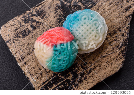 Chinese mooncake is an Asian sweet dessert. Asian mooncake as a background for your design 129993095