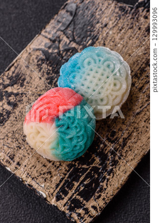 Chinese mooncake is an Asian sweet dessert. Asian mooncake as a background for your design 129993096