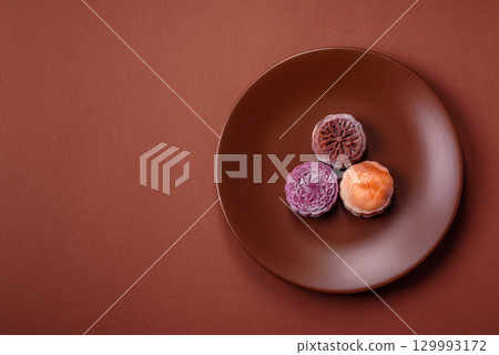 Chinese mooncake is an Asian sweet dessert. Asian mooncake as a background for your design 129993172