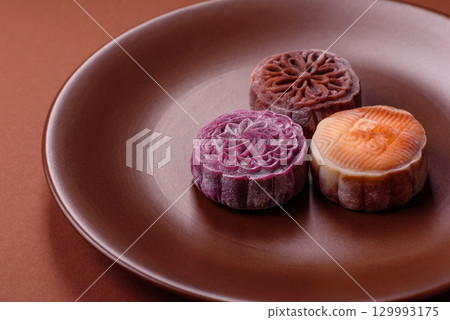 Chinese mooncake is an Asian sweet dessert. Asian mooncake as a background for your design 129993175