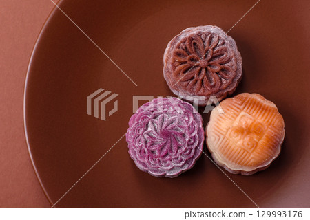 Chinese mooncake is an Asian sweet dessert. Asian mooncake as a background for your design Chinese mooncake is an Asian sweet dessert. Asian mooncake as a background for your design 129993176