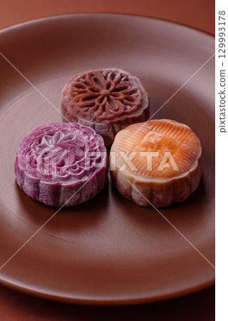 Chinese mooncake is an Asian sweet dessert. Asian mooncake as a background for your design 129993178