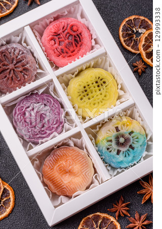 Chinese mooncake is an Asian sweet dessert. Asian mooncake as a background for your design Chinese mooncake is an Asian sweet dessert. Asian mooncake as a background for your design 129993338